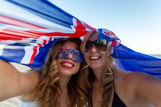 Two ecstatic happy patriotic women celebrate Australia Day