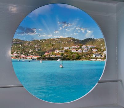 View of a sunlit bay through a ships porthole