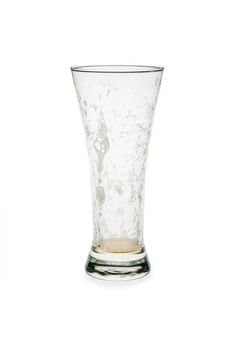 Empty pilsner glass isolated against white background. glass with foam on the inside.