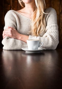 close up Woman with cappuccino on wooden table