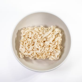 The close up of Taiwanese instant dry noodles in white bowl on white background.