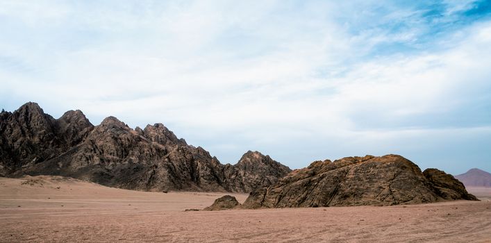 rocky mountains in the desert without people and blue sky with clouds in sharm el sheikh egypt landscape