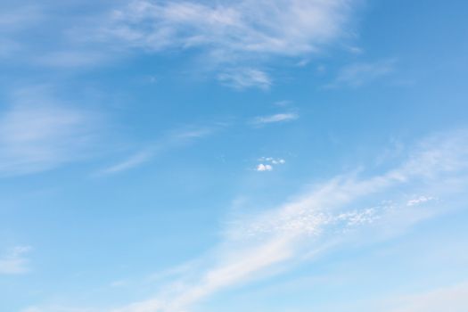 Light cirrus clouds in the blue sky on a sunny day, full frame image, background.