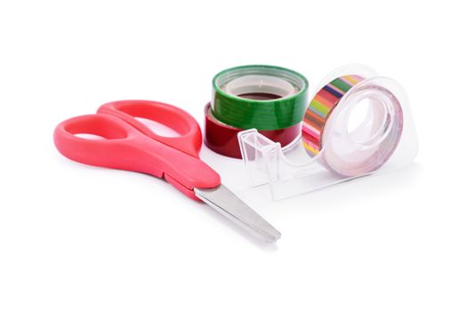 DIY gift wrapping concept. Close up of colorful washi tapes and red scissors, isolated on white background.
