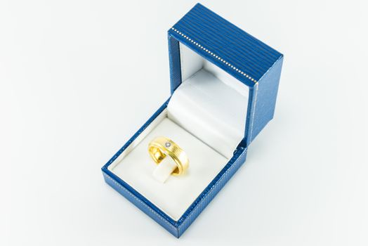 Diamond ring in Blue Box on white background.