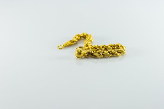 Gold bracelet on white background.