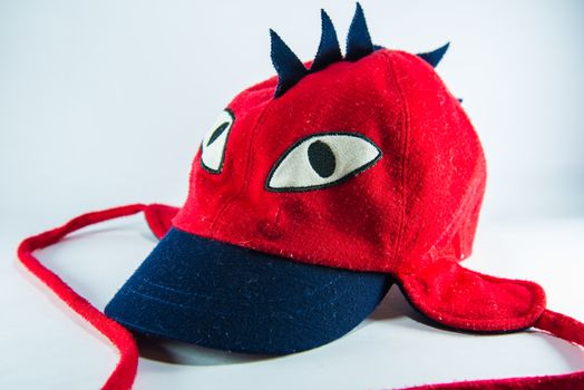 Red children cap on white background.