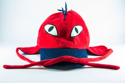 Red children cap on white background.