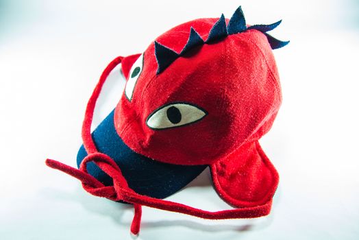 Red children cap on white background.