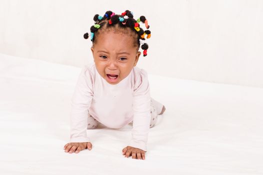 Photo of baby crawling towards his mother crying isolated on white background