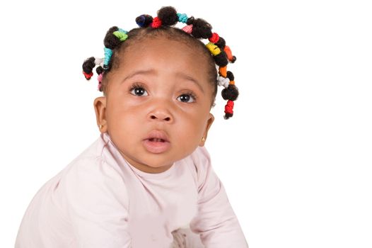 Portrait of cute baby girl looking at camera on a white background.