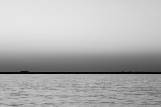 a wide seascape shoot with very well composed colors and black horizon from izmir bay - black and white. photo has taken at izmir/turkey.