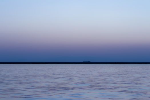 a wide seascape shoot with very well composed colors and black horizon from izmir bay - blue color dominated. photo has taken at izmir/turkey.