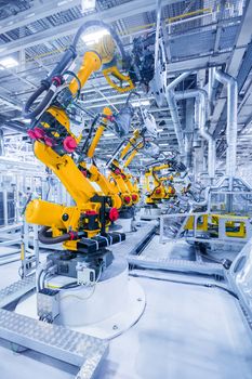 robotic arms in a car plant