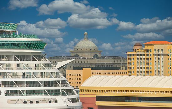 A cruise ship docked in a busy port city