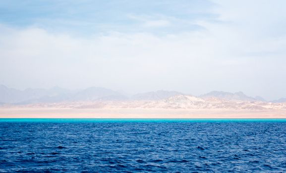 Red Sea landscape and coast with rocky mountains and a blue sky with clouds in Sharm El Sheikh Egypt