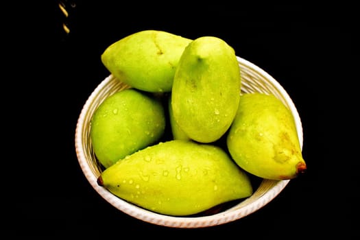 Green mangoes in a Basket