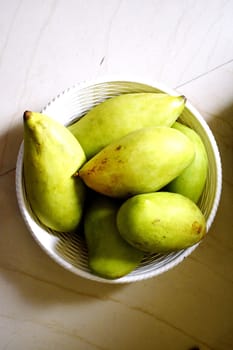 Green mangoes in a Basket