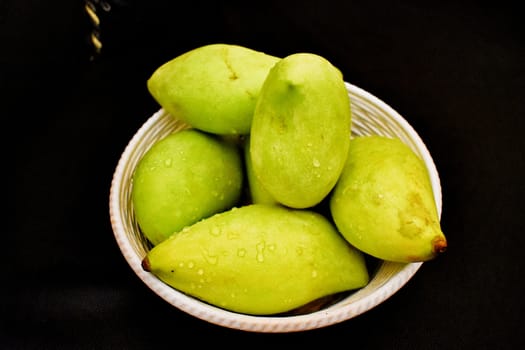 Green mangoes in a Basket