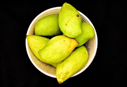 Green mangoes in a Basket