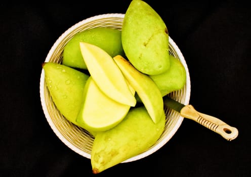 Green mangoes in a Basket