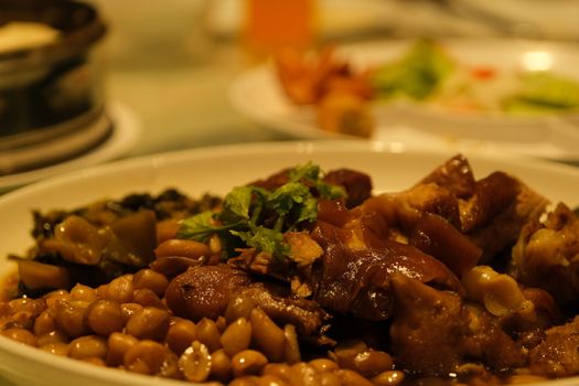 The Beef stew with potatoes, carrots and herbs on black background with copy space, side view