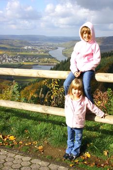 two blond girls with Mosel Valley in the background