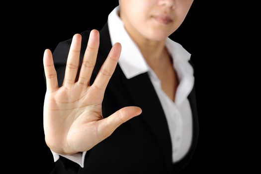 Serious business woman shows stop sign talk to hand gesture isolated on black background. 