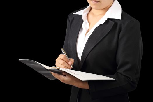 Businesswoman holding a pen for signing or writing isolated on black background, clipping path.