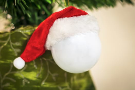 hanging decorative white ball for Christmas tree with Red Hat of Santa Claus