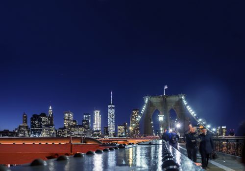New York night skyline seen from the Brooklyn Bridge pedestrian path