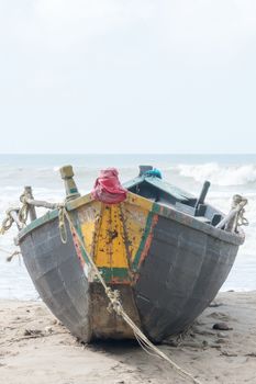 An abandoned fishing boat trawler used in fishing industry spotted in a commercial dock near riverbank arena in a remote location of the Sundarbans jetty. Close up. Summer environment.