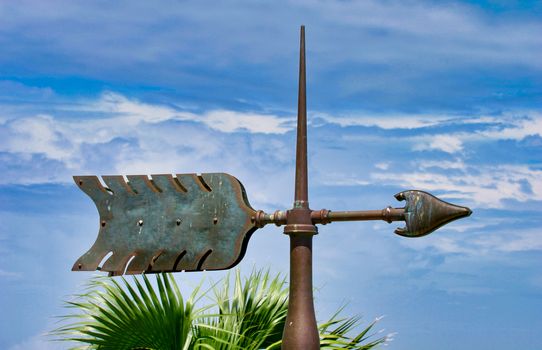 An old iron weathervane in the shape of an arrow