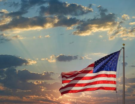 An American flag backlit by the sun