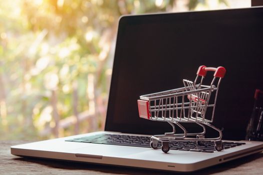 Shopping online concept - Empty shopping cart or trolley on a laptop keyboard. Shopping service on The online web. offers home delivery.
