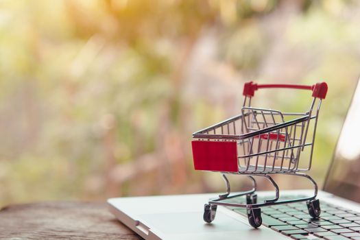 Shopping online concept - Empty shopping cart or trolley on a laptop keyboard. Shopping service on The online web. offers home delivery.
