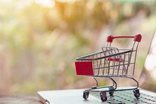 Shopping online concept - Empty shopping cart or trolley on a laptop keyboard. Shopping service on The online web. offers home delivery.
