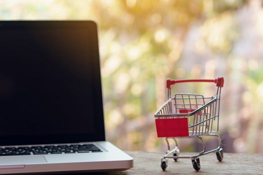 Shopping online concept - Empty shopping cart or trolley on a laptop keyboard. Shopping service on The online web. offers home delivery.
