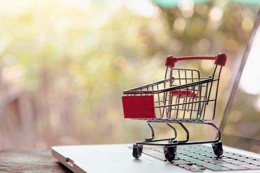 Shopping online concept - Empty shopping cart or trolley on a laptop keyboard. Shopping service on The online web. offers home delivery.

