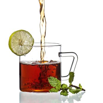 Cup of tea, mint and lemon on white background