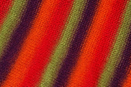 Knit woolen texture. Fabric multicolor background. Bright colors of warm natural fabric.