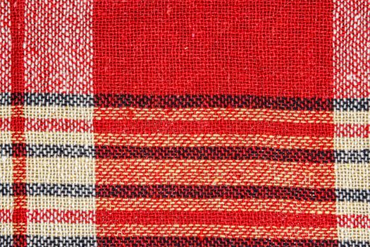 Texture of linen fabric with a bright red check pattern. Country style.