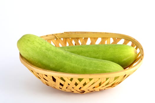 Fresh Cucumbers in basket isolated on white background