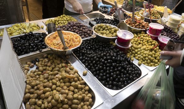 market stall selling olives in green black and all different varieties