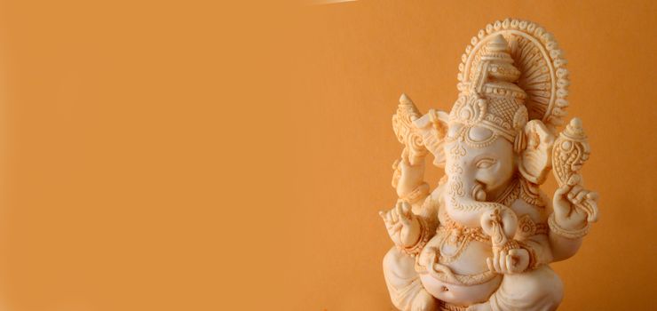 Hindu God Ganesha. Ganesha Idol on yellow background