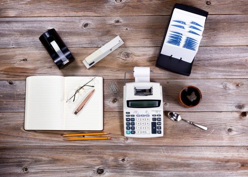 Overhead view of business desktop with supplies and objects from the past. 