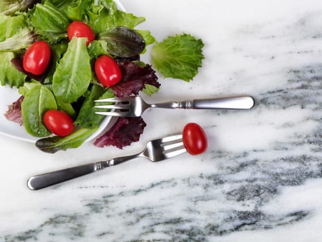 Organic healthy salad in flat view layout on natural marble.  