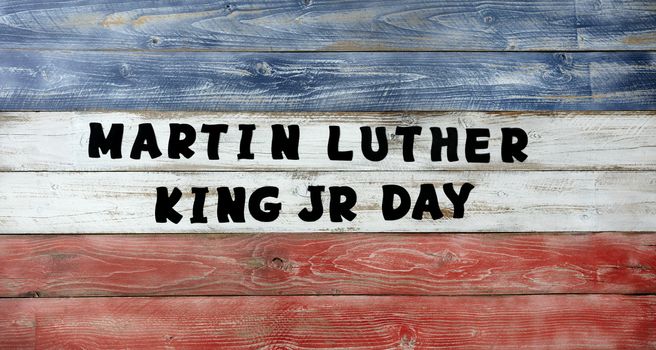 Martin Luther King JR Day large text letters on red, white and blue wooden boards