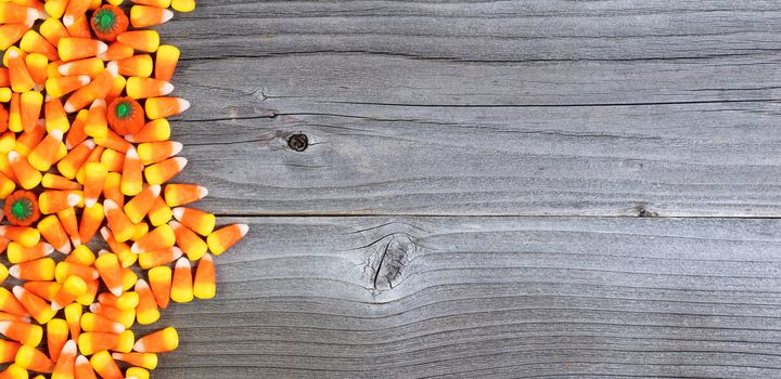 Halloween candy forming left border on weathered wood