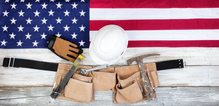 Red, white and blue American flag with industrial tools for Labor Day background